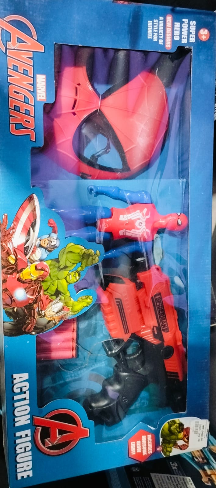 Packaged action figure gun toy with a red and black design, featuring character motifs from the Avengers.