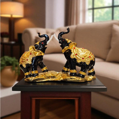 Decorative black and gold elephant statues on a table in a living room setting.