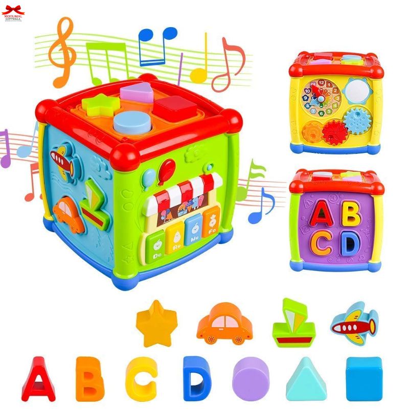 Colorful toy cube with musical notes, shapes, and letters on a white background