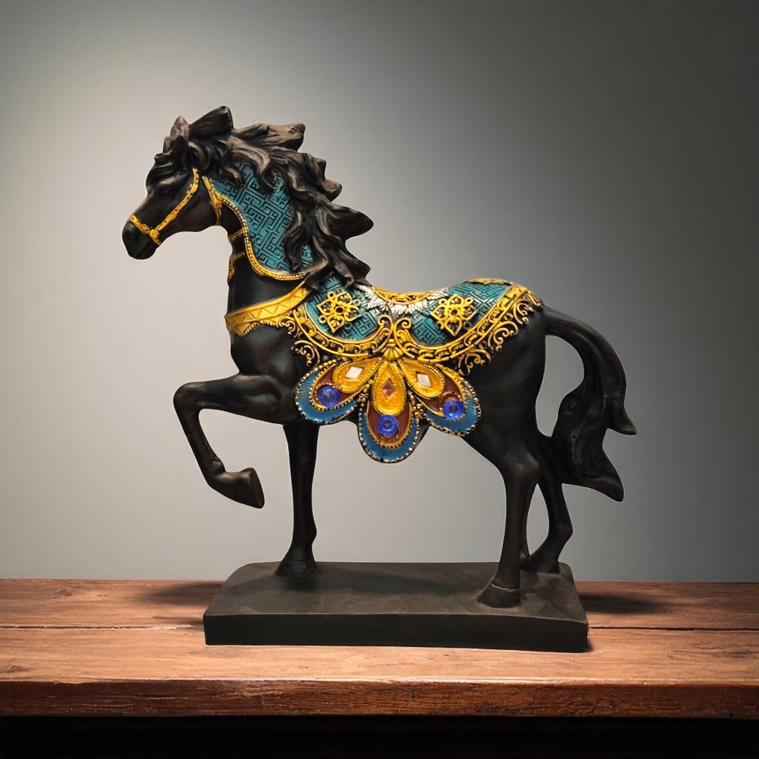 Front view of black horse showpiece with ornate peacock saddle design