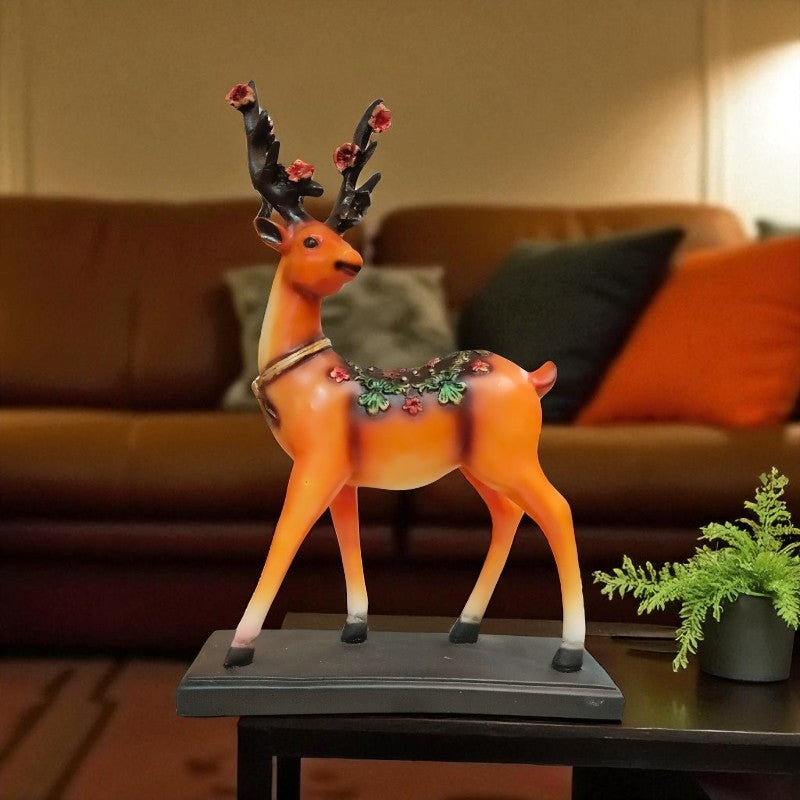 Decorative deer figurine with floral decorations on a table in a living room setting.