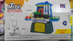 Box of a toy mini kitchen set with colorful design and text on a white background
