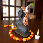 Side view of Adiyogi Mahadev sculpture with calm expression and white crescent moon