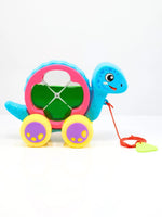 Colorful toy turtle with wheels on a white background