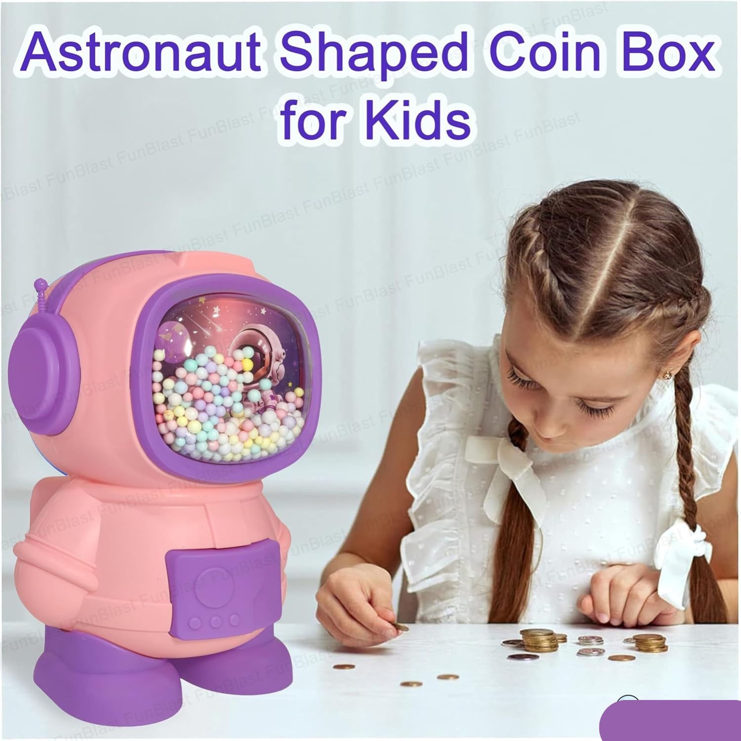 Smiling boy saving money in astronaut piggy bank toy from Motumal Giftwala.
