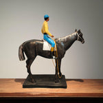 Side profile of horse rider statue in bright outfit