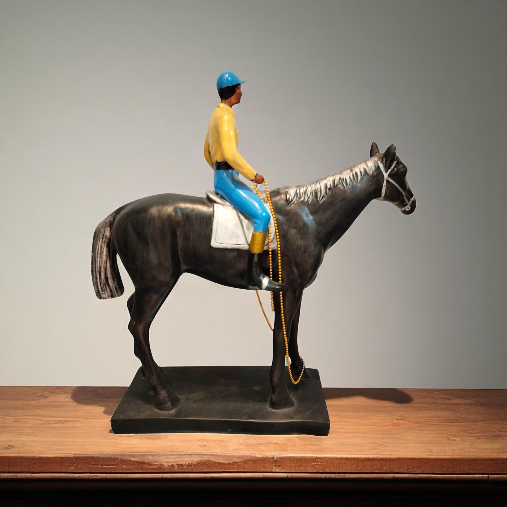 Side profile of horse rider statue in bright outfit