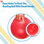Red bowling ball with holes for small hands, held by a hand.
