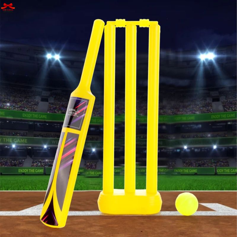 Yellow cricket bat and stumps on a virtual cricket pitch with lights and spectators in the background