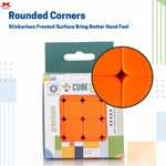 Orange Rubik's Cube with packaging and close-up of rounded corners on a white background