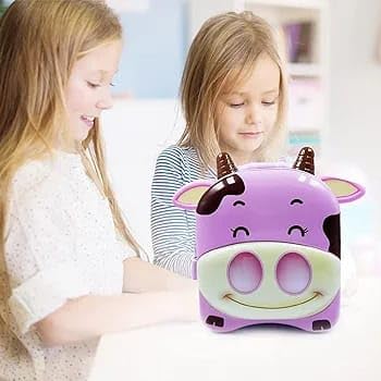 Two kids playing with cute purple cow piggy bank money box
