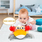 Baby playing with a toy crab in a room with a bed and pillows.