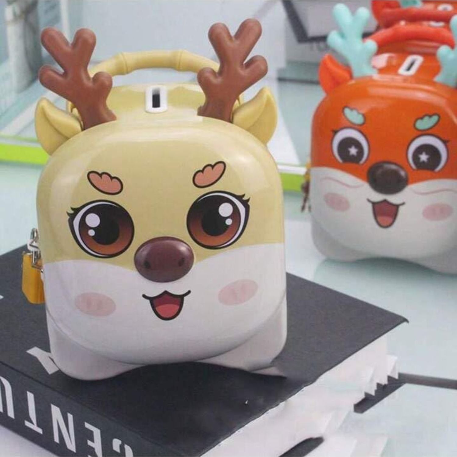 Set of colorful reindeer metal piggy banks in pink, orange, yellow, and purple colors, perfect for children gifts and savings, Motumal Giftwala