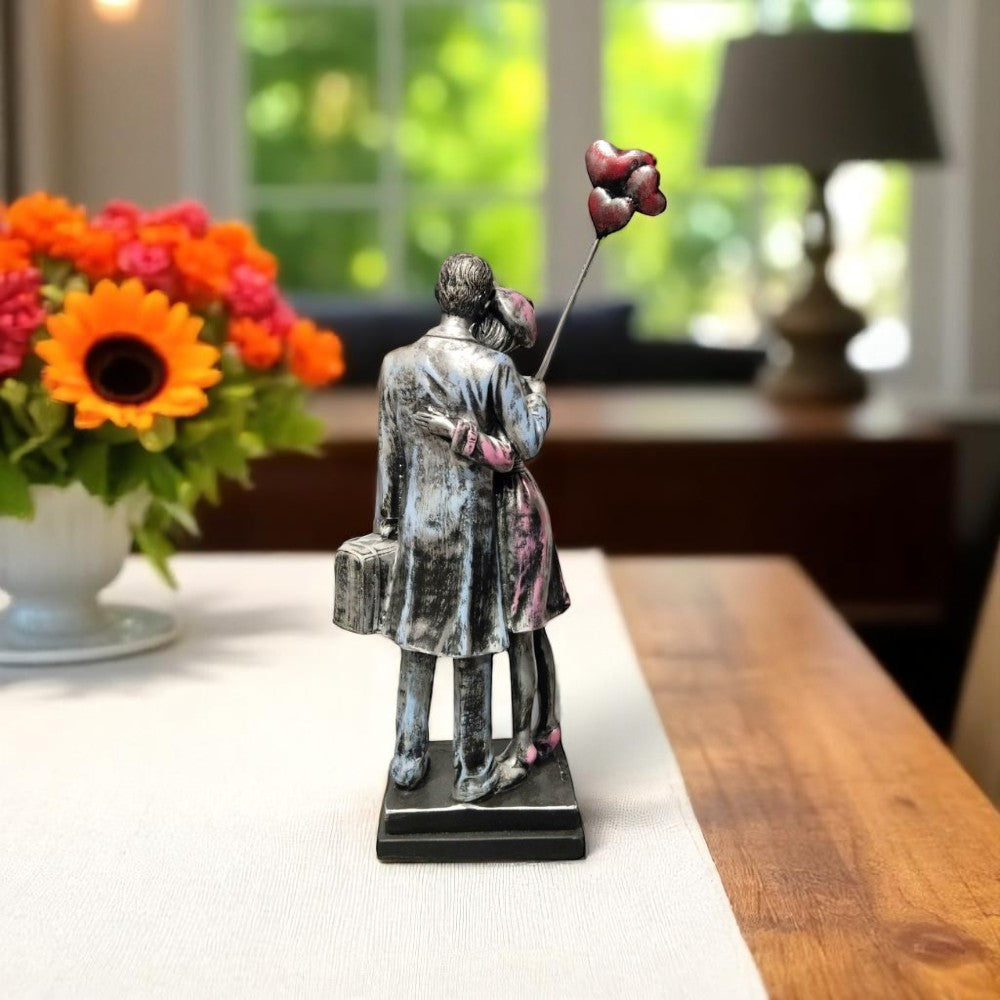 Romantic showpiece of couple hugging with suitcase and balloons - back view - Motumal Giftwala