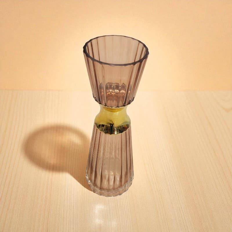 Glass vase with ribbed design on a wooden surface