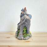 Decorative elephant figurine on a wooden surface with a white background