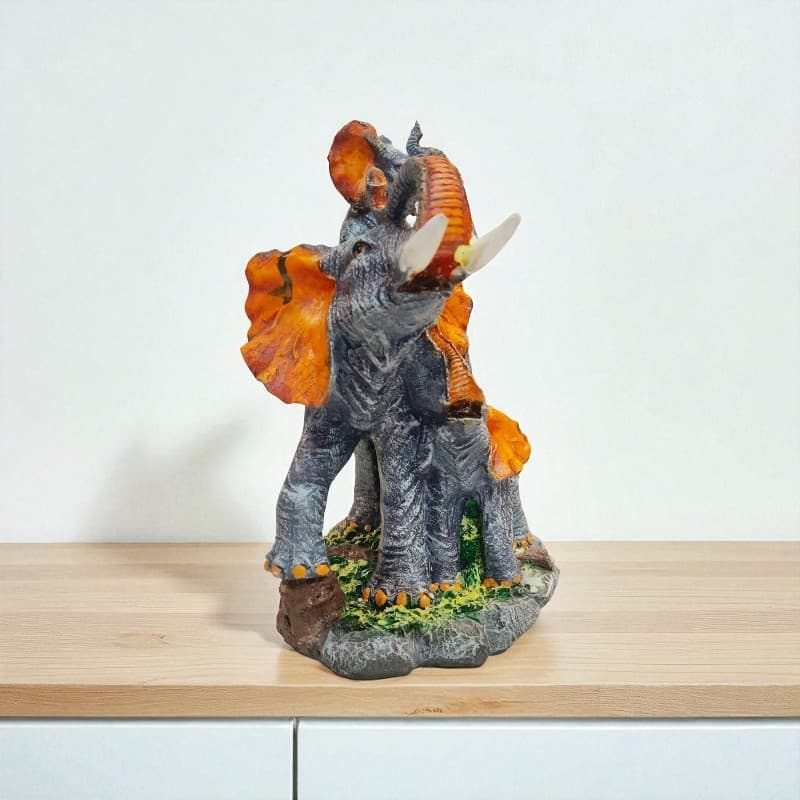 Decorative triceratops figurine on a wooden surface with a white background