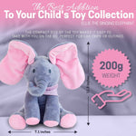Plush elephant toy with pink ears and feet, labeled as 'Ellie the Singing Elephant', on a purple background.