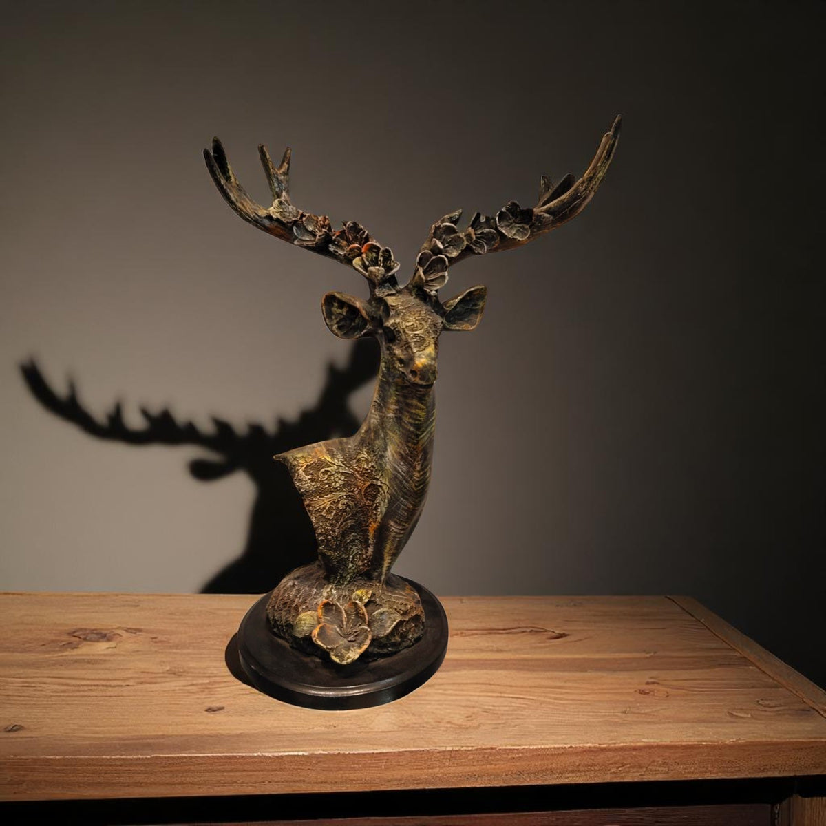  Deer head sculpture front view with antlers on wooden table