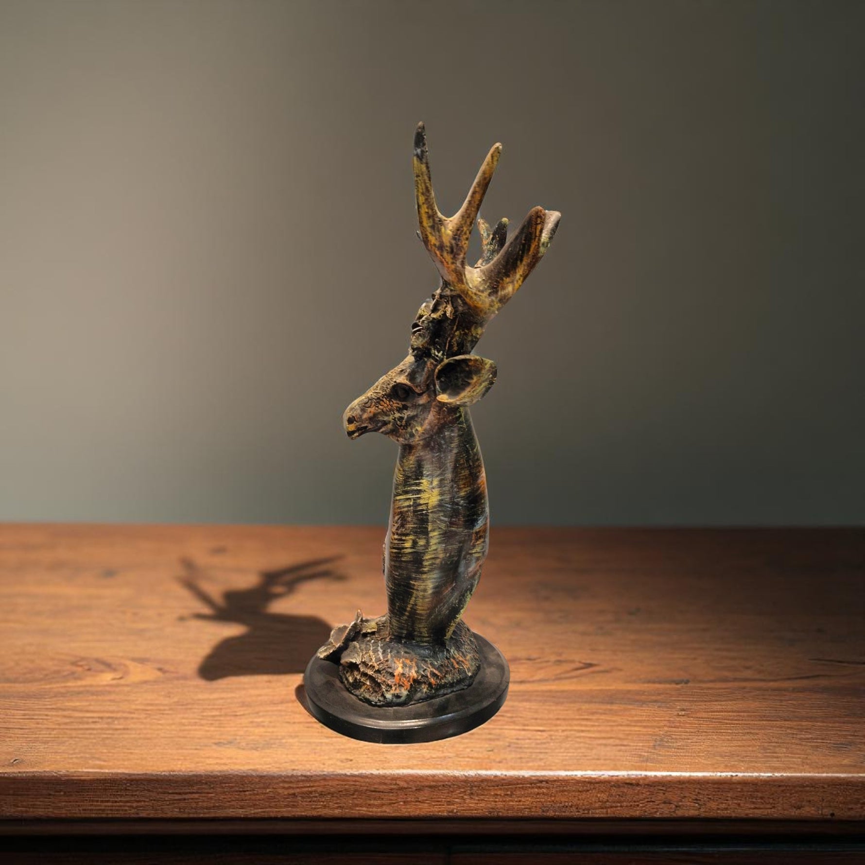  Antique deer bust side profile on wooden shelf
