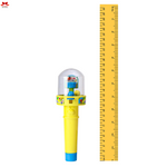 Yellow toy bubble gun with a ruler on a white background