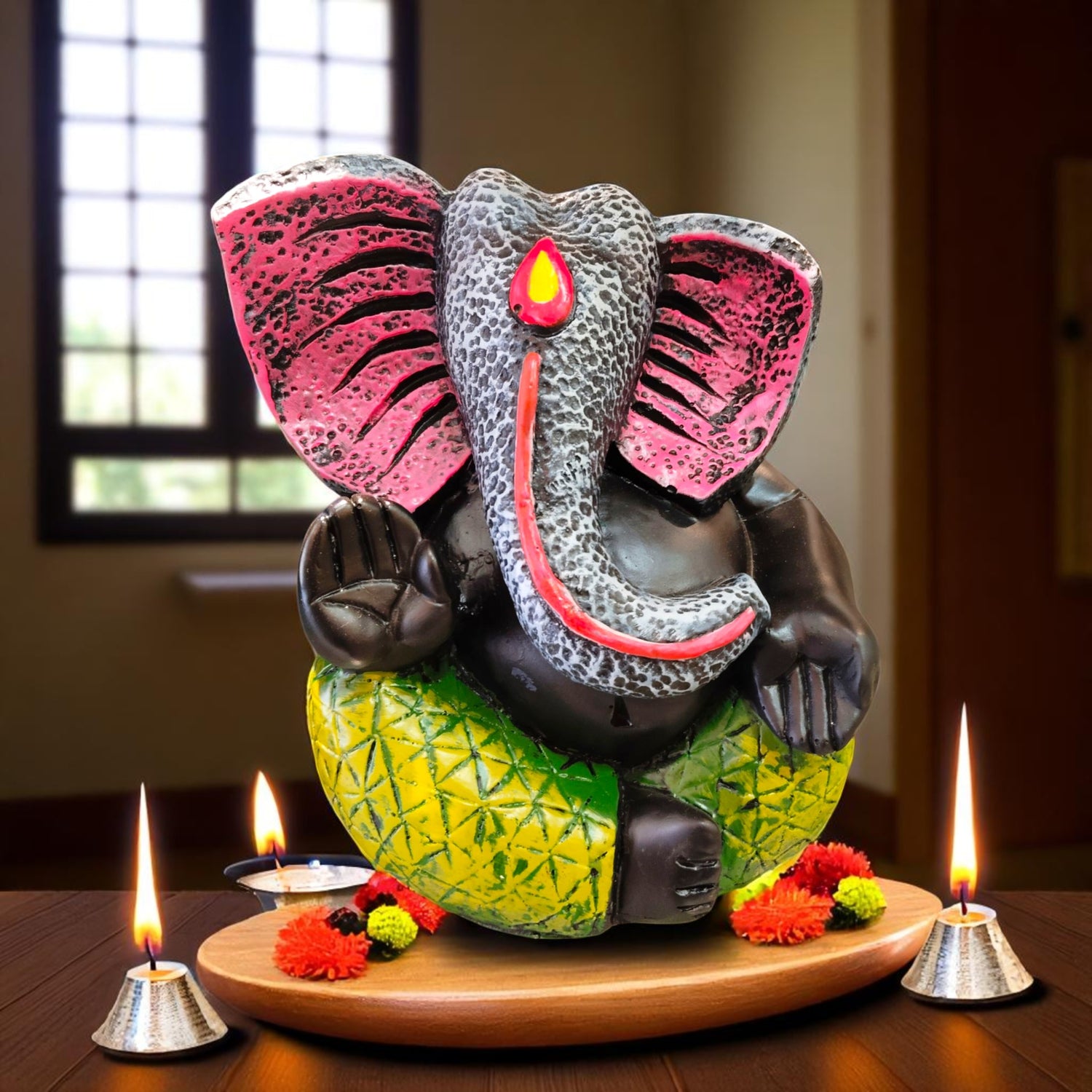 Front view of black stone Ganesha idol on pineapple base