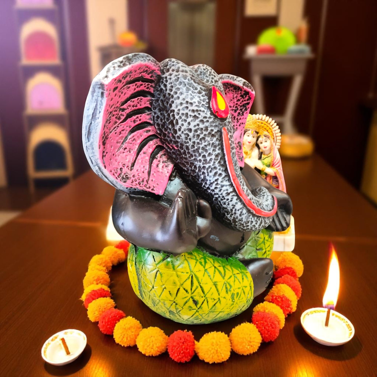 Decorative side angle of Ganesha with diya and marigold