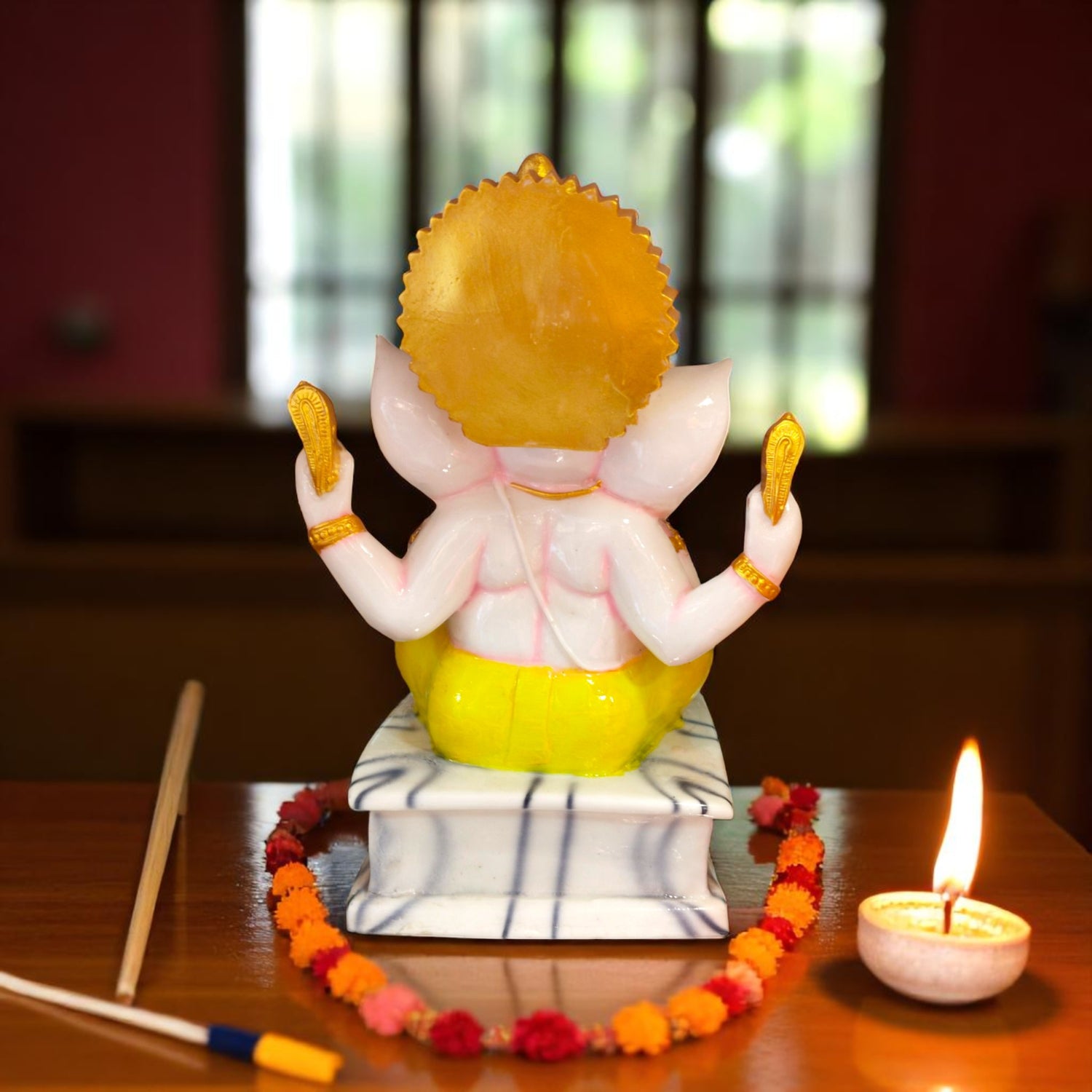 Rear view of Ganesh murti showing crown and singhasan detail