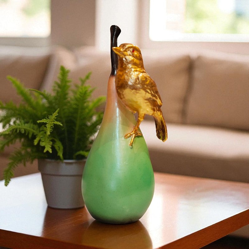 Green vase with a bird ornament on a table in a living room setting