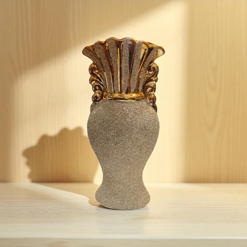 Decorative vase with gold accents on a wooden surface