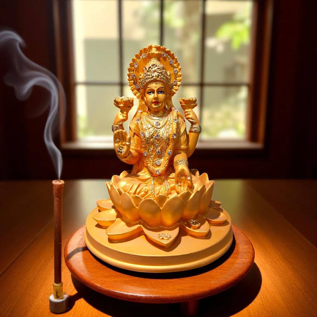 Front view of Lakshmi Ji idol with diya and agarbatti