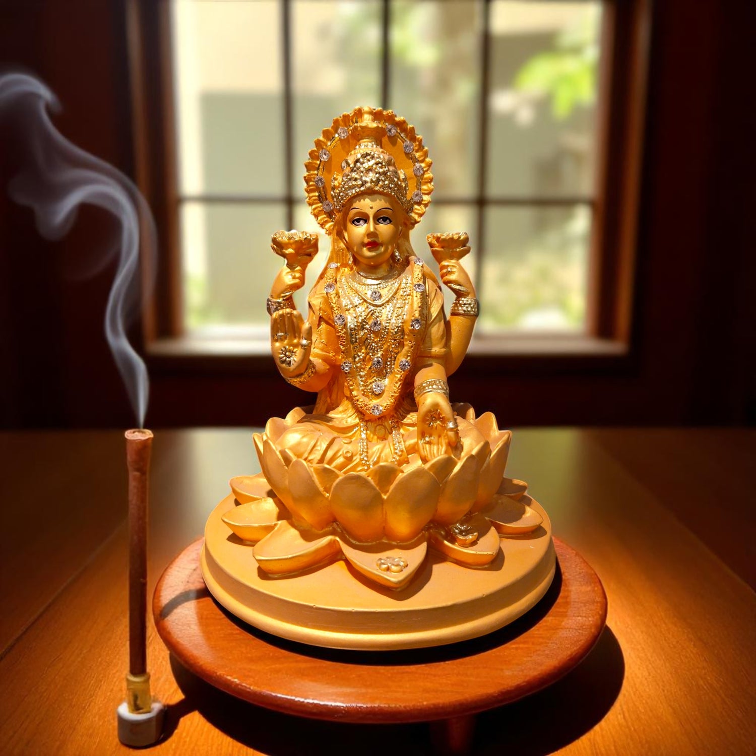 Front view of Lakshmi Ji idol with diya and agarbatti