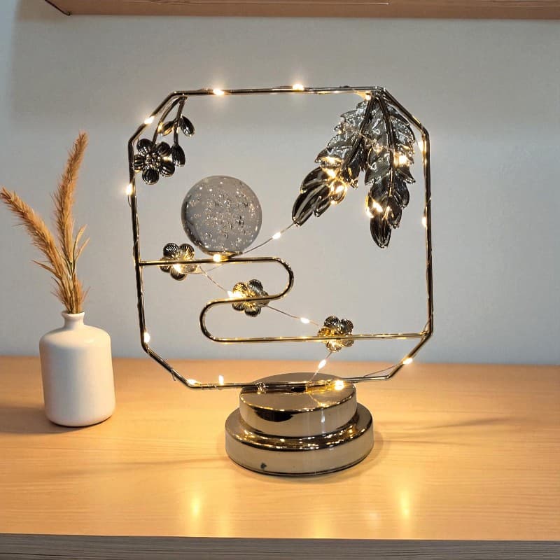 Decorative lamp with floral design on a wooden surface
