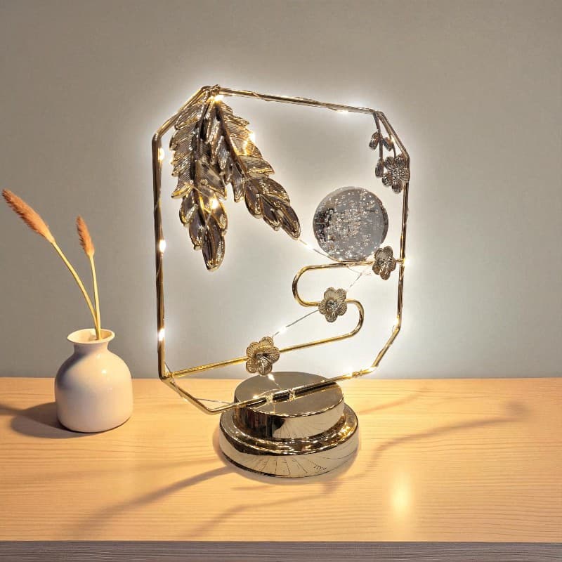 Decorative lamp with feathers on a wooden surface