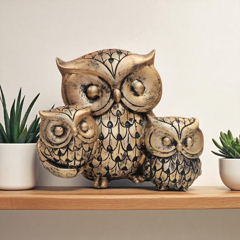 Decorative owl sculpture on a shelf with plants in the background