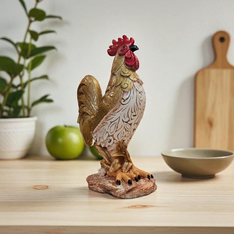 Decorative rooster figurine on a wooden surface with a plant and bowl in the background