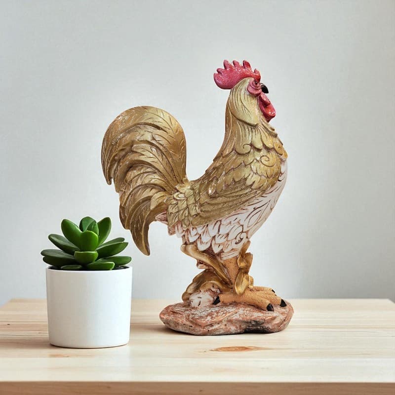 Decorative rooster statue next to a small potted plant on a wooden surface with a light gray background
