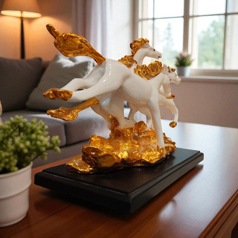 Decorative sculpture of two white horses with gold accents on a black base in a living room setting.