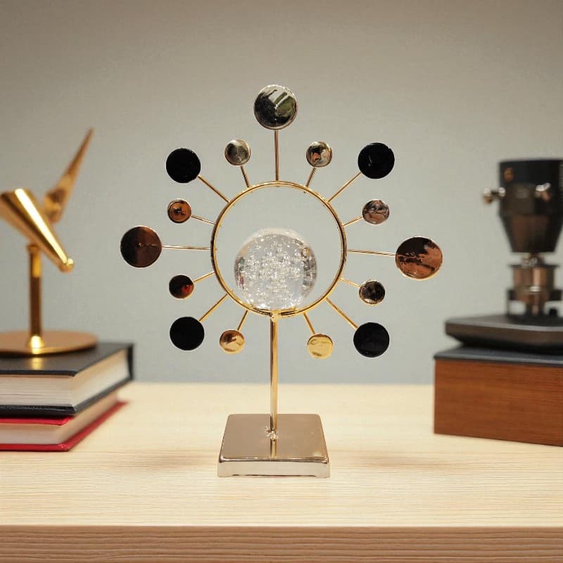 Decorative object with gold and black design on a wooden surface
