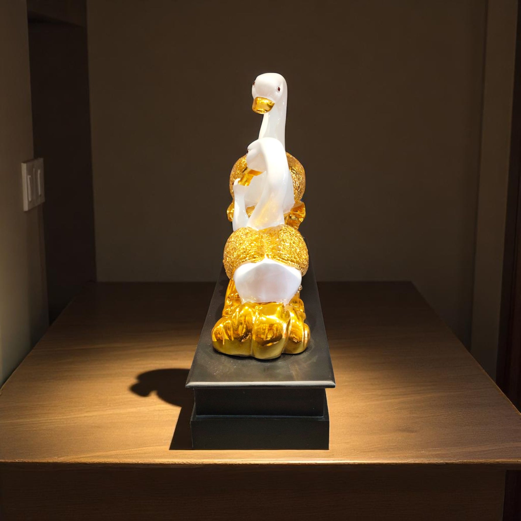 Rear view showing intricate golden tail details of swan figurine