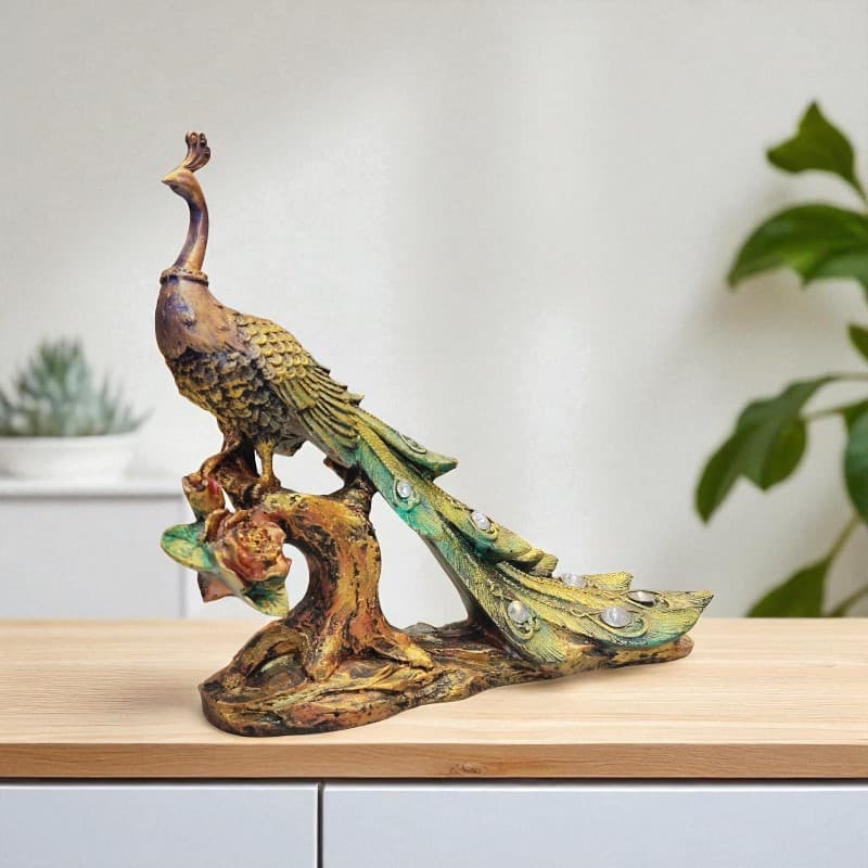 Decorative peacock statue on a wooden surface with a neutral background