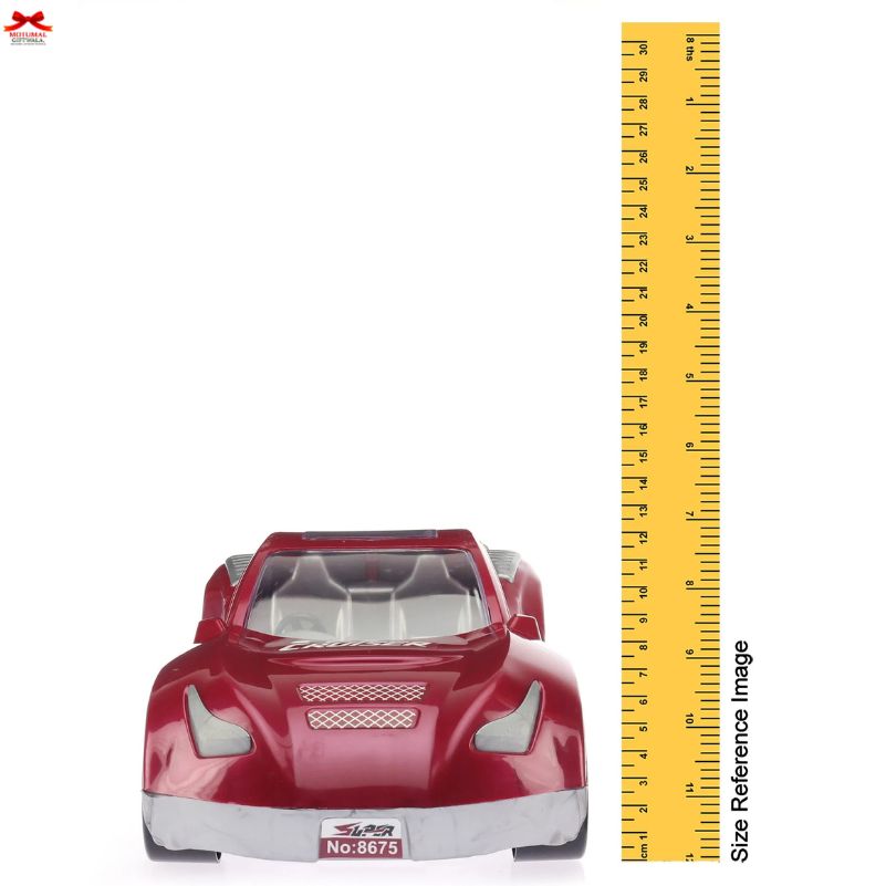 Red toy car next to a yellow ruler for size reference on a white background