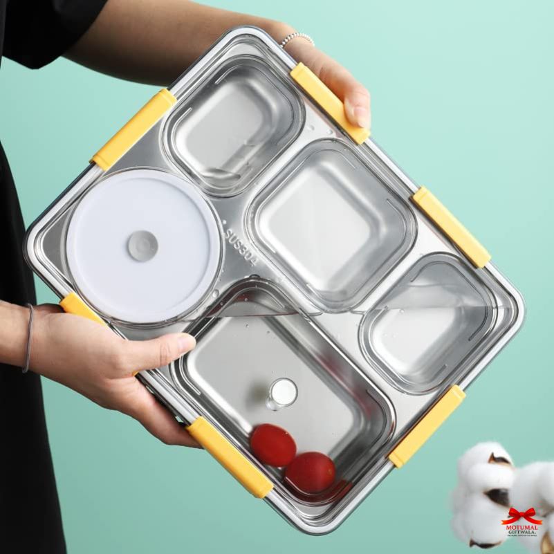 Stainless steel food container with yellow handles held by a person on a teal background