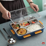 Bento box with compartments filled with food on a table
