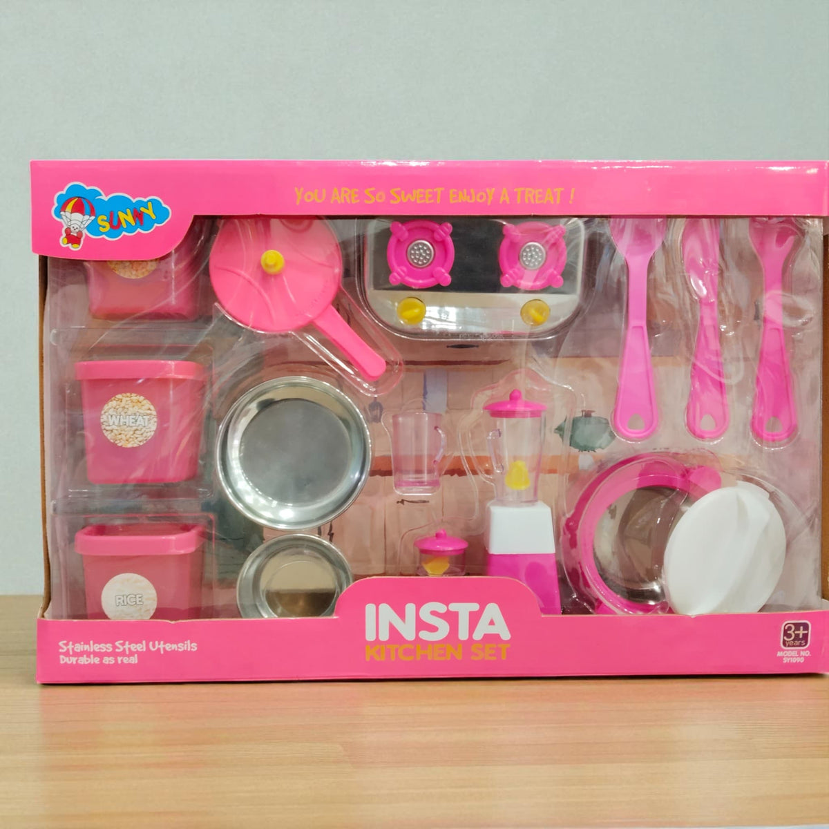Front view of Insta Kitchen Set toy packaging with utensils, stove, and mixer visible