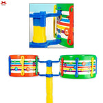 Colorful toy musical instrument set with drums and a stand on a white background.
