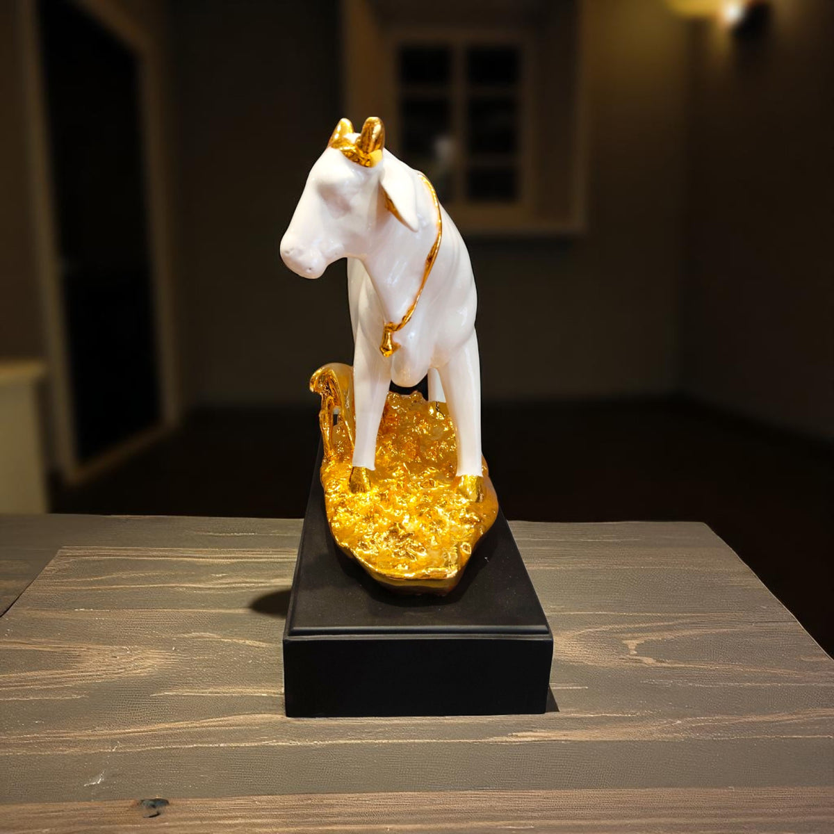  Side view of white resin cow idol with golden calf