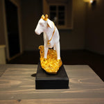  Side view of white resin cow idol with golden calf