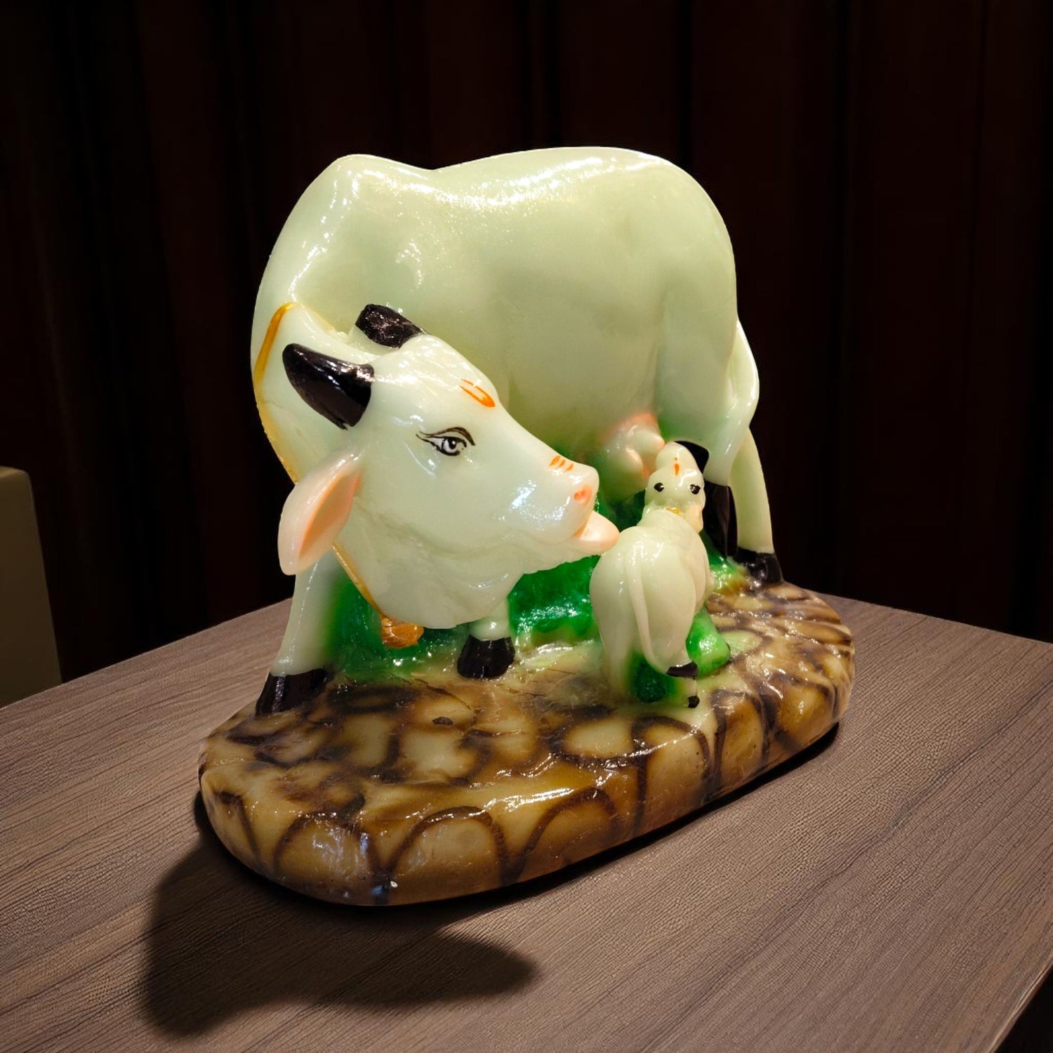 Side angle of divine cow with calf showpiece for puja or decor