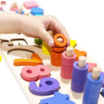 Colorful wooden number and shape sorting toy with a hand interacting with it.